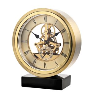 Asztali óra - kerek, aranyozott. Stílusos és korszerű, csiszolt aranyszínű alumíniumból készült kerek asztali óra "lebegő" számlappal és csontvázas szerkezetű óraszerkezettel.